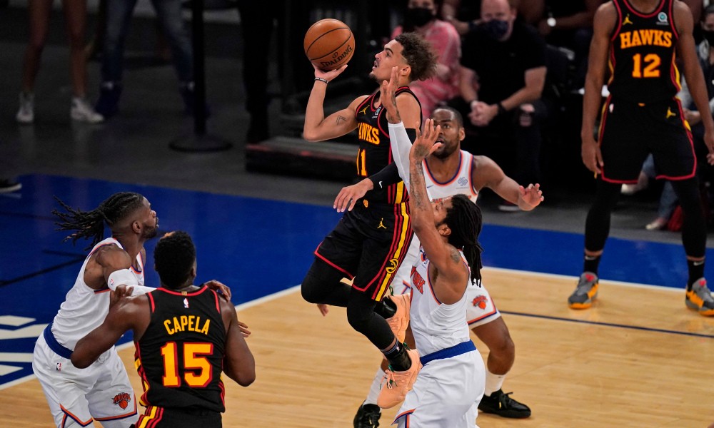 Atlanta Hawks' Trae Young, center, drives to the basket during the first half of Game 1 of an NBA basketball first-round playoff series against the New York Knicks, Sunday, May 23, 2021, in New York. (AP Photo/Seth Wenig, Pool) ORG XMIT: NYSW736