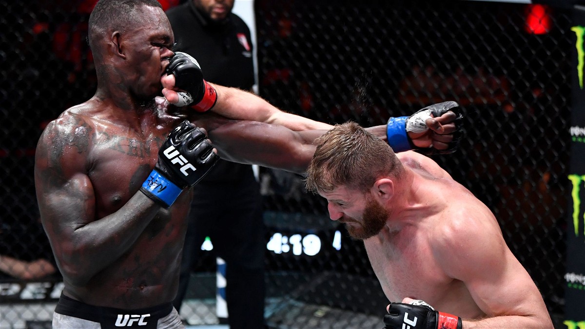 Jan Blachowicz throws a right punch on the nose of Israel Adesanya at UFC 259