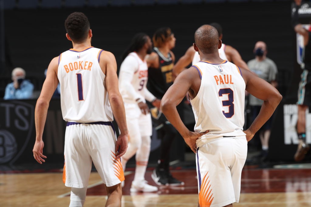 Chris Paul and Devin Booker of Phoenix Suns stand together
