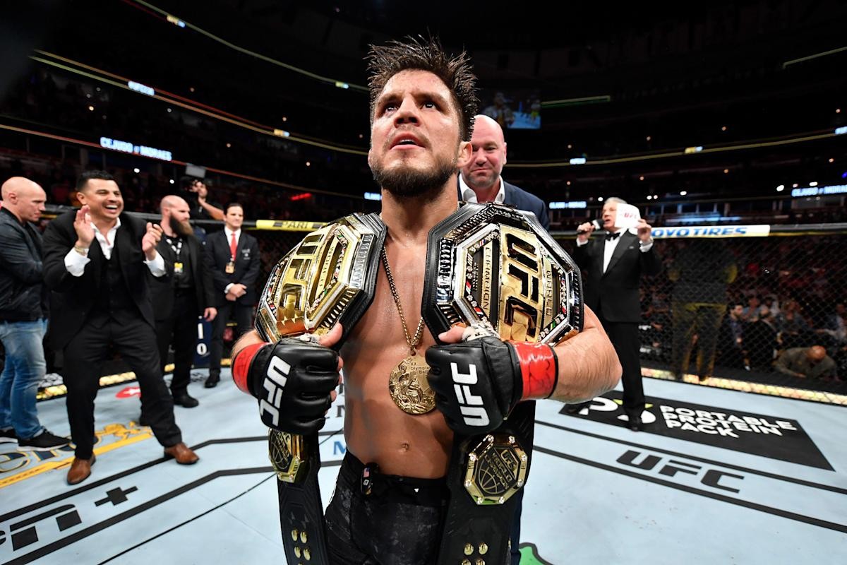 Henry Cejudo with both of his titles