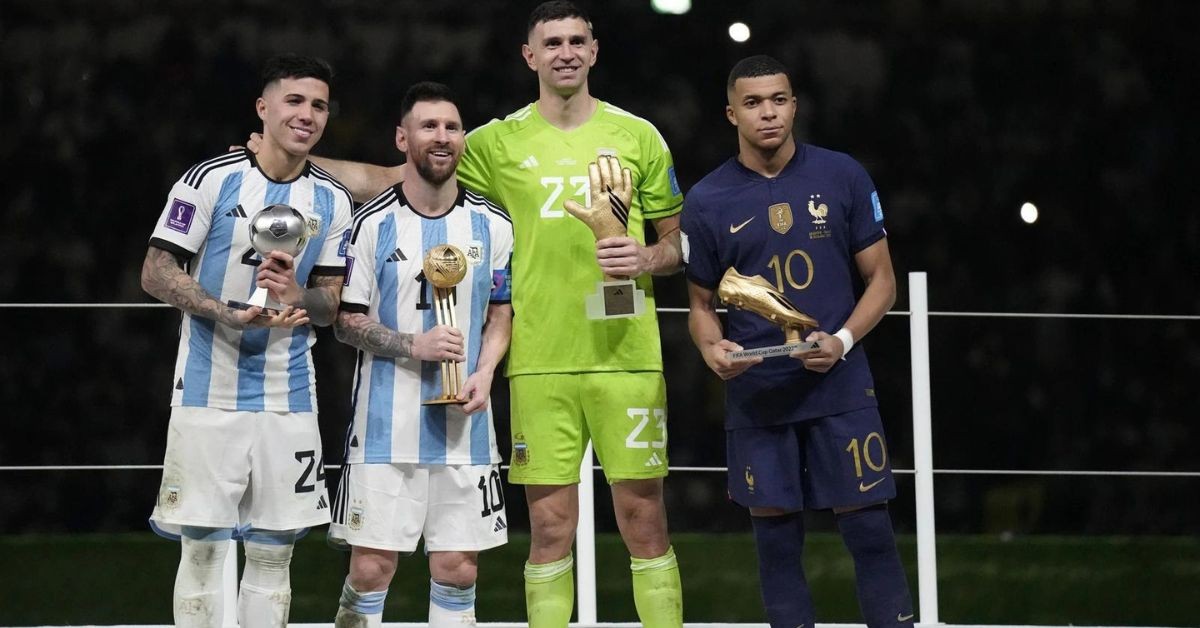 From left to right: Enzo Fernandez, Lionel Messi, Emiliano Martinez, and Kylian Mbappe pose with their individual awards of the FIFA World Cup 2022