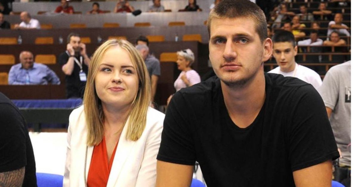 Nikola Jokic and his wife Natalija sitting courtside 