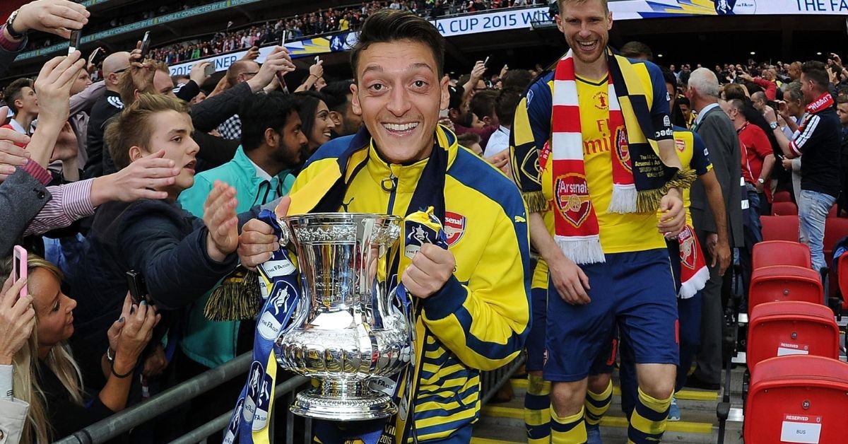 Mesut Ozil celebrating the FA Cup with Arsenal