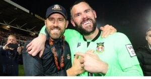 Wrexham owner Ryan Reynolds and Ben Foster celebrate Wrexham's promotion (CREDITS: IAN COOPER PHOTOGRAPHY)