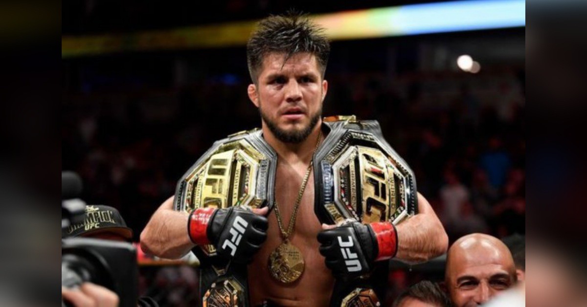Henry Cejudo with UFC titles and Olympic Gold Medal